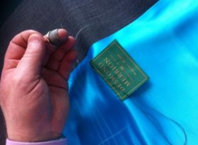 Me hand stitching my label into a clients made to measure suit